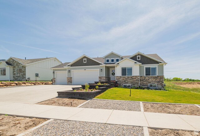 638 E Canyon Rim Rd N, Smithfield, UT 84335 - craftsman-style home with stone siding, an attached garage, driveway, and a front yard