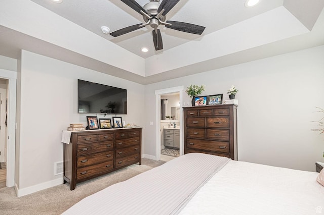 638 E Canyon Rim Rd N, Smithfield, UT 84335 - bedroom featuring a tray ceiling, ensuite bathroom, ceiling fan, and light colored carpet