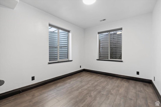 2493 S Aster Way, Saratoga Springs, UT 84045 - unfurnished room featuring visible vents, baseboards, and wood finished floors