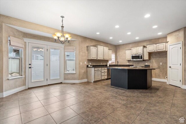 2493 S Aster Way, Saratoga Springs, UT 84045 - kitchen with dark countertops, a center island, stainless steel microwave, and a notable chandelier