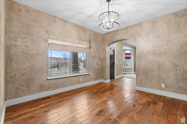 2493 S Aster Way, Saratoga Springs, UT 84045 - unfurnished room with a healthy amount of sunlight, hardwood / wood-style flooring, visible vents, and arched walkways
