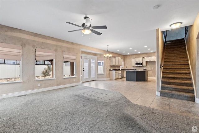 2493 S Aster Way, Saratoga Springs, UT 84045 - unfurnished living room featuring visible vents, stairway, light carpet, light tile patterned flooring, and ceiling fan with notable chandelier