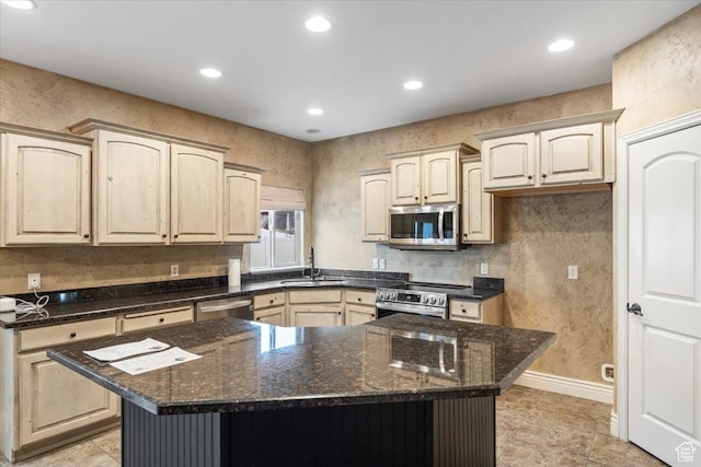 2493 S Aster Way, Saratoga Springs, UT 84045 - kitchen with dark stone counters, a center island, stainless steel appliances, a sink, and recessed lighting