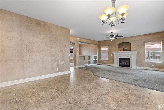2493 S Aster Way, Saratoga Springs, UT 84045 - unfurnished living room with ceiling fan with notable chandelier, a glass covered fireplace, and baseboards