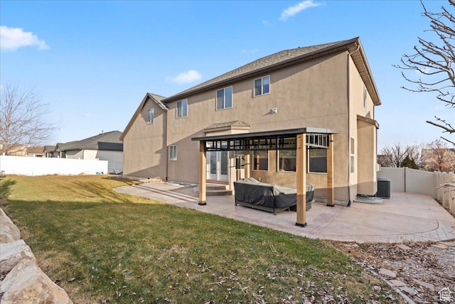 2493 S Aster Way, Saratoga Springs, UT 84045 - back of house featuring a fenced backyard, central AC, a yard, stucco siding, and a patio area
