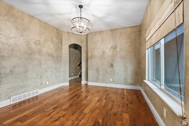 2493 S Aster Way, Saratoga Springs, UT 84045 - unfurnished room featuring an inviting chandelier, wood-type flooring, visible vents, and arched walkways