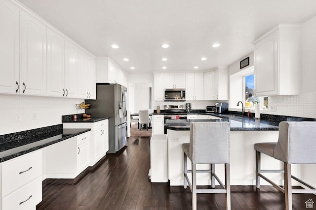 582 W 3900 N, Pleasant View, UT 84414 - kitchen featuring a kitchen breakfast bar, white cabinetry, sink, and appliances with stainless steel finishes