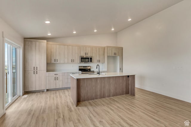 706 W Osborne Way S Unit 803, Grantsville, UT 84029 - kitchen featuring stainless steel appliances, sink, light brown cabinets, a center island with sink, and light hardwood / wood-style flooring