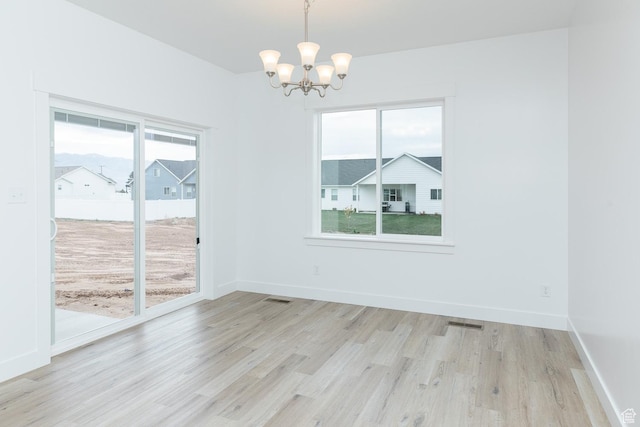 732 E 750 S, Preston, ID 83263 - unfurnished dining area featuring a notable chandelier, light wood-style floors, baseboards, and visible vents