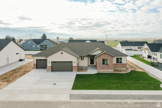 732 E 750 S, Preston, ID 83263 - view of front of home with a front yard, fence, brick siding, an attached garage, and driveway
