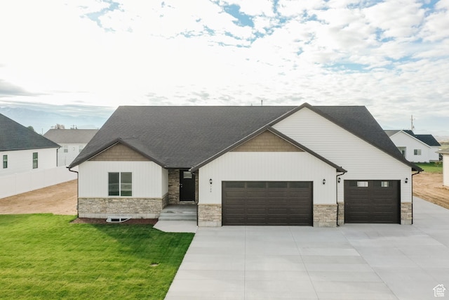 732 E 750 S, Preston, ID 83263 - modern farmhouse style home with concrete driveway, a front yard, stone siding, and an attached garage