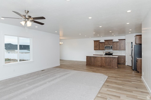 732 E 750 S, Preston, ID 83263 - kitchen featuring ceiling fan with notable chandelier, recessed lighting, a kitchen island, appliances with stainless steel finishes, and open floor plan