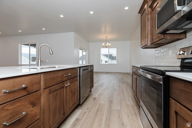 732 E 750 S, Preston, ID 83263 - kitchen featuring a sink, light countertops, a chandelier, stainless steel appliances, and light wood-style flooring