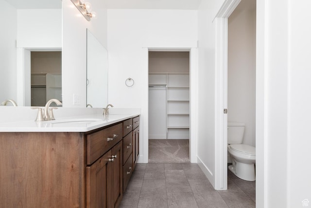 732 E 750 S, Preston, ID 83263 - bathroom featuring baseboards, a sink, a spacious closet, toilet, and double vanity