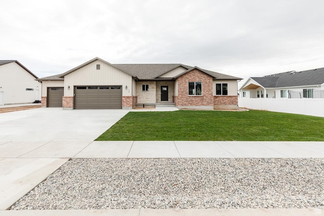 732 E 750 S, Preston, ID 83263 - view of front of home with board and batten siding, a garage, fence, brick siding, and concrete driveway