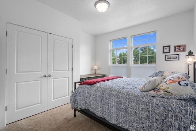 bedroom featuring a closet and carpet flooring
