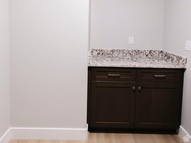 interior details featuring wood finished floors and baseboards