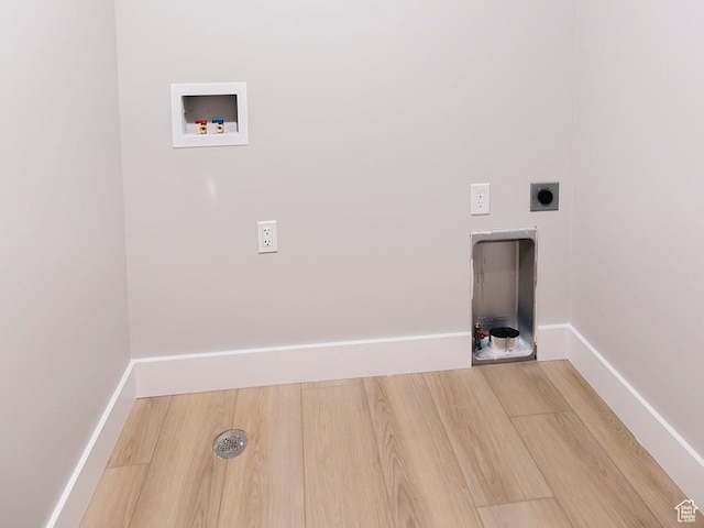 laundry room with hookup for an electric dryer, wood finished floors, laundry area, and washer hookup