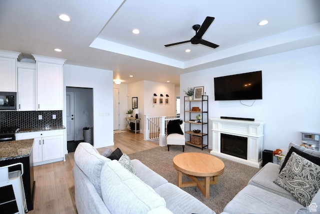 2129 N 3000 W, Plain City, UT 84404 - living area with recessed lighting, light wood-type flooring, a raised ceiling, and a fireplace