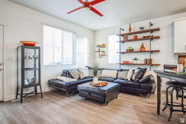 living room featuring ceiling fan and light hardwood / wood-style floors