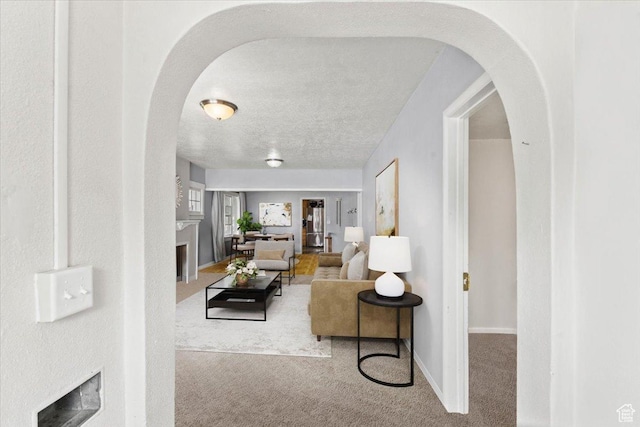207 E 300 N, Logan, UT 84321 - living room featuring arched walkways, baseboards, carpet floors, and a fireplace