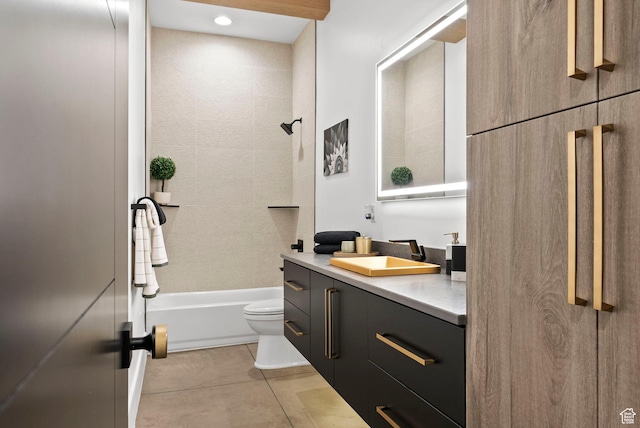 full bathroom with tile patterned floors, tiled shower / bath, vanity, and toilet