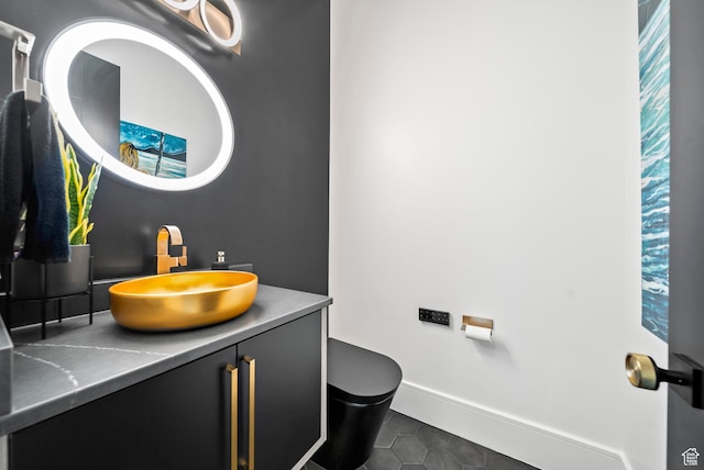 bathroom with tile patterned floors, vanity, and toilet