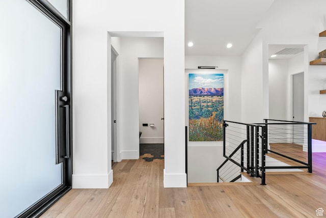hall with light hardwood / wood-style flooring