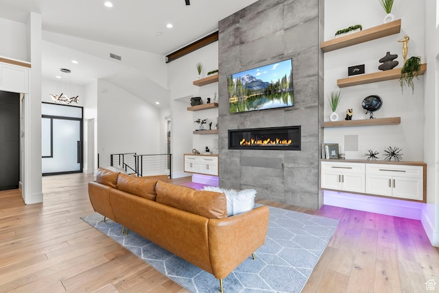 living room featuring light hardwood / wood-style floors and a tile fireplace