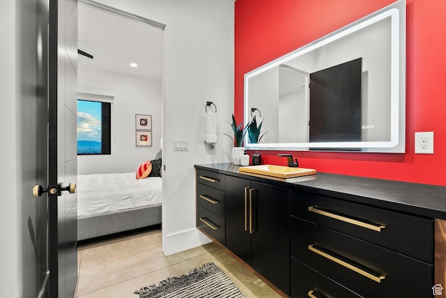 bathroom with tile patterned flooring and vanity