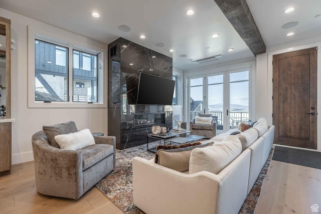 1269 Rothwell Rd, Park City, UT 84060 - living room with a fireplace, light hardwood / wood-style flooring, beamed ceiling, and plenty of natural light