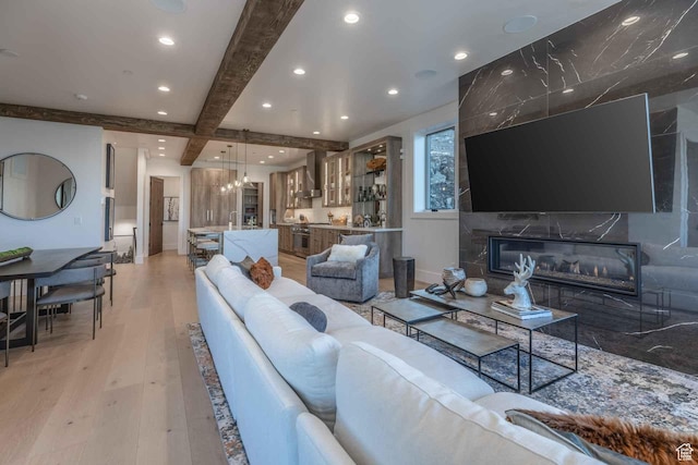 1269 Rothwell Rd, Park City, UT 84060 - living room with beam ceiling, light hardwood / wood-style floors, and a premium fireplace