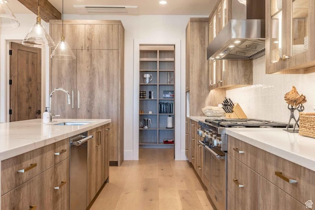 1269 Rothwell Rd, Park City, UT 84060 - kitchen featuring light wood-type flooring, sink, wall chimney range hood, decorative light fixtures, and high end stainless steel range