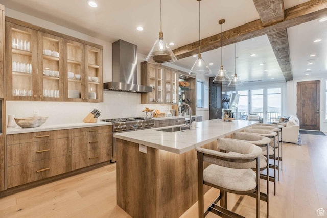 1269 Rothwell Rd, Park City, UT 84060 - kitchen with a spacious island, wall chimney range hood, sink, decorative light fixtures, and light hardwood / wood-style floors