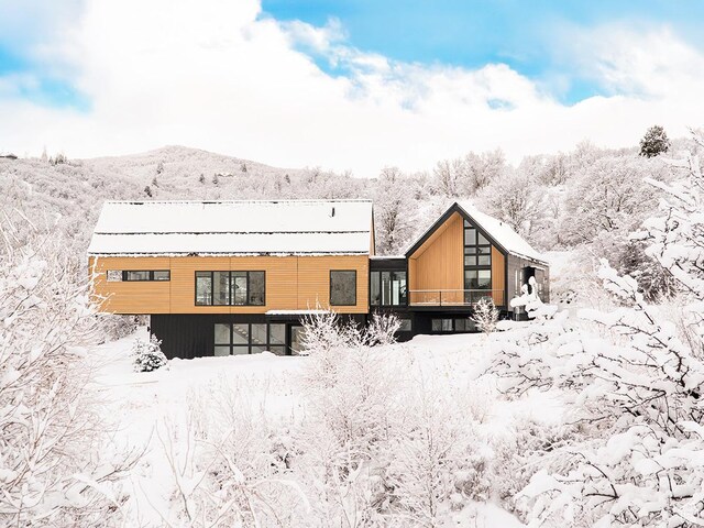 snow covered property with a mountain view