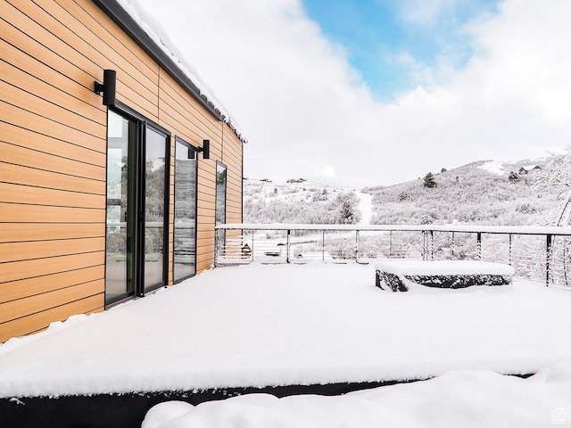 snowy yard featuring a mountain view