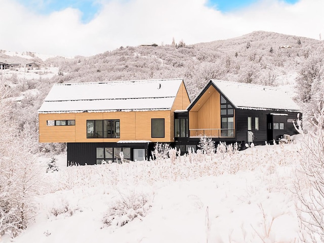 snow covered house with a mountain view