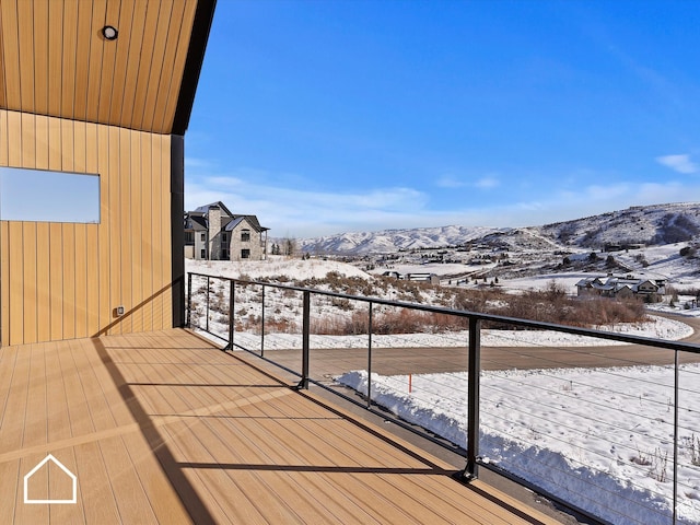 snow covered deck with a mountain view