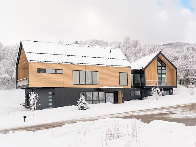 snow covered property with a garage