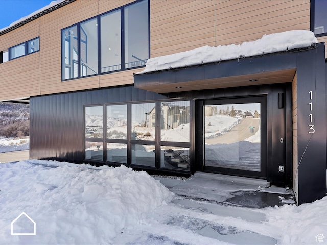 view of snow covered property entrance