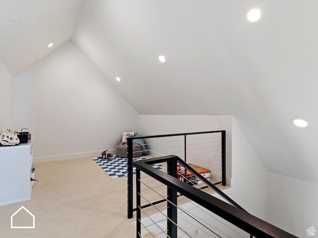 interior space with light carpet and lofted ceiling
