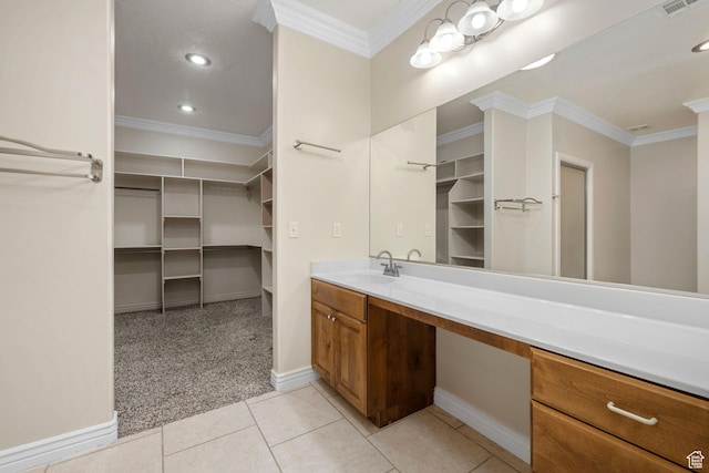 bathroom with tile patterned floors, vanity, a spacious closet, and ornamental molding