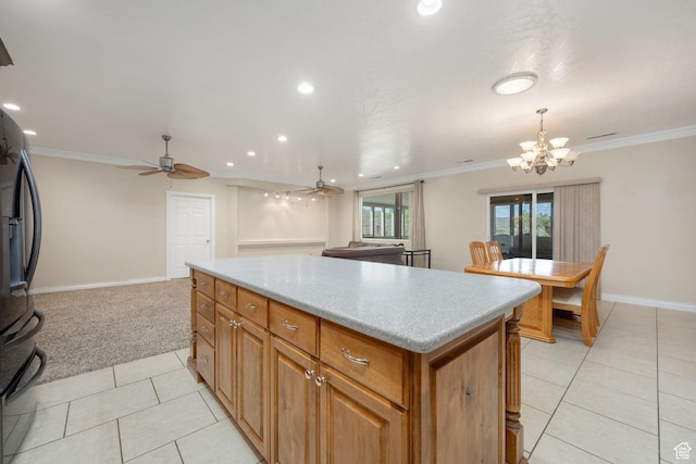 kitchen with a center island, open floor plan, baseboards, black fridge with ice dispenser, and light tile patterned floors