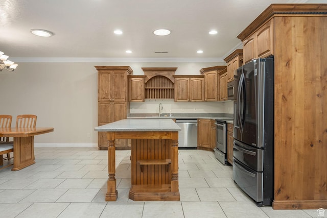 kitchen featuring light countertops, crown molding, a center island, and stainless steel appliances