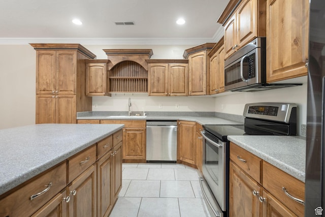 kitchen with light countertops, visible vents, a sink, crown molding, and appliances with stainless steel finishes