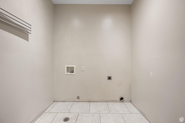 washroom with light tile patterned floors, hookup for a washing machine, laundry area, and hookup for an electric dryer