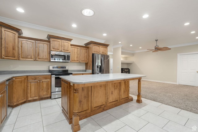 kitchen featuring light colored carpet, recessed lighting, appliances with stainless steel finishes, and a kitchen island