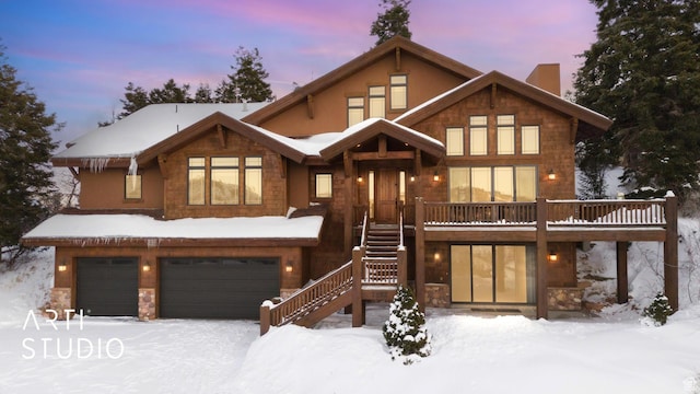 view of front of home featuring a garage and a wooden deck