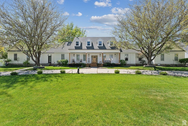 cape cod home featuring a front lawn
