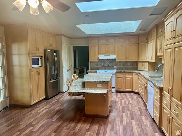 1581 E 6470 S, Murray, UT 84121 - kitchen featuring white appliances, a skylight, a sink, under cabinet range hood, and dark wood-style flooring